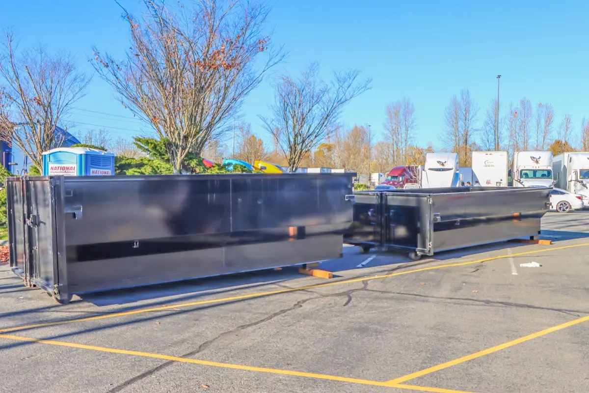 Professional dumpster rental service with roll-off container on residential driveway in Columbia